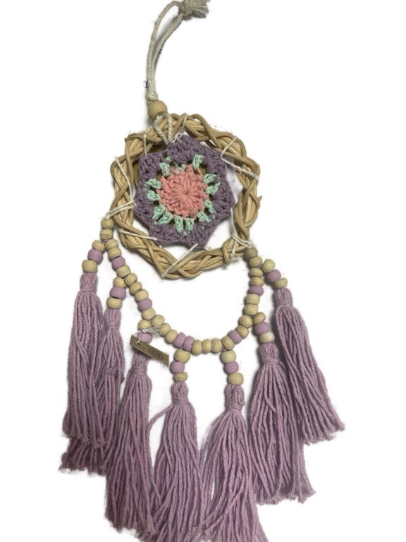 Decorative dreamcatcher with tassels on a white background