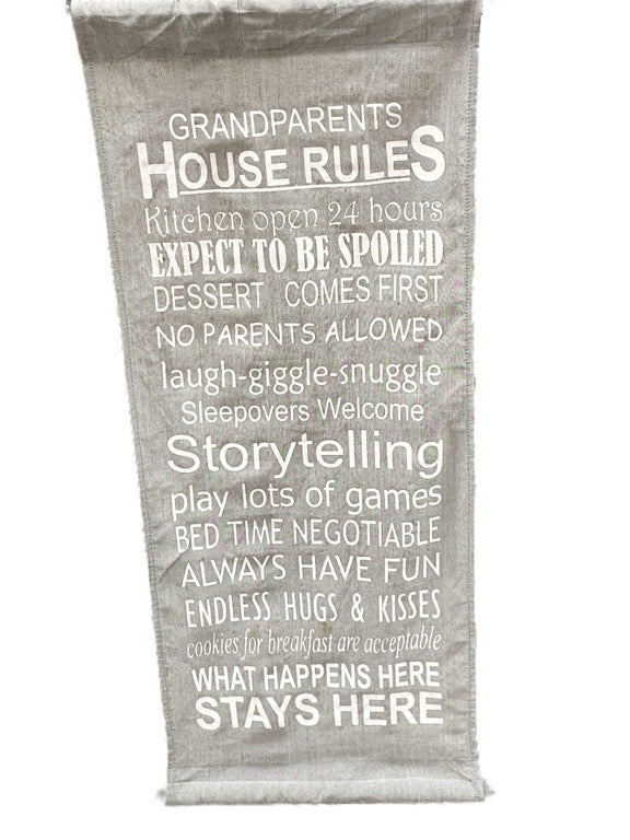 Textile with 'Grandparents House Rules' printed on a white background