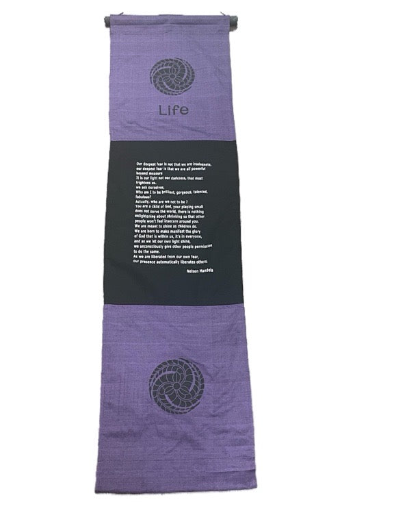 Purple and black towel with text and symbols on a white background