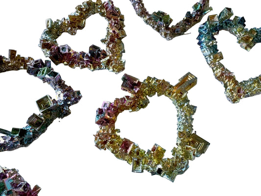 Decorative letters spelling 'LOVE' made of small colorful crystals on a white background