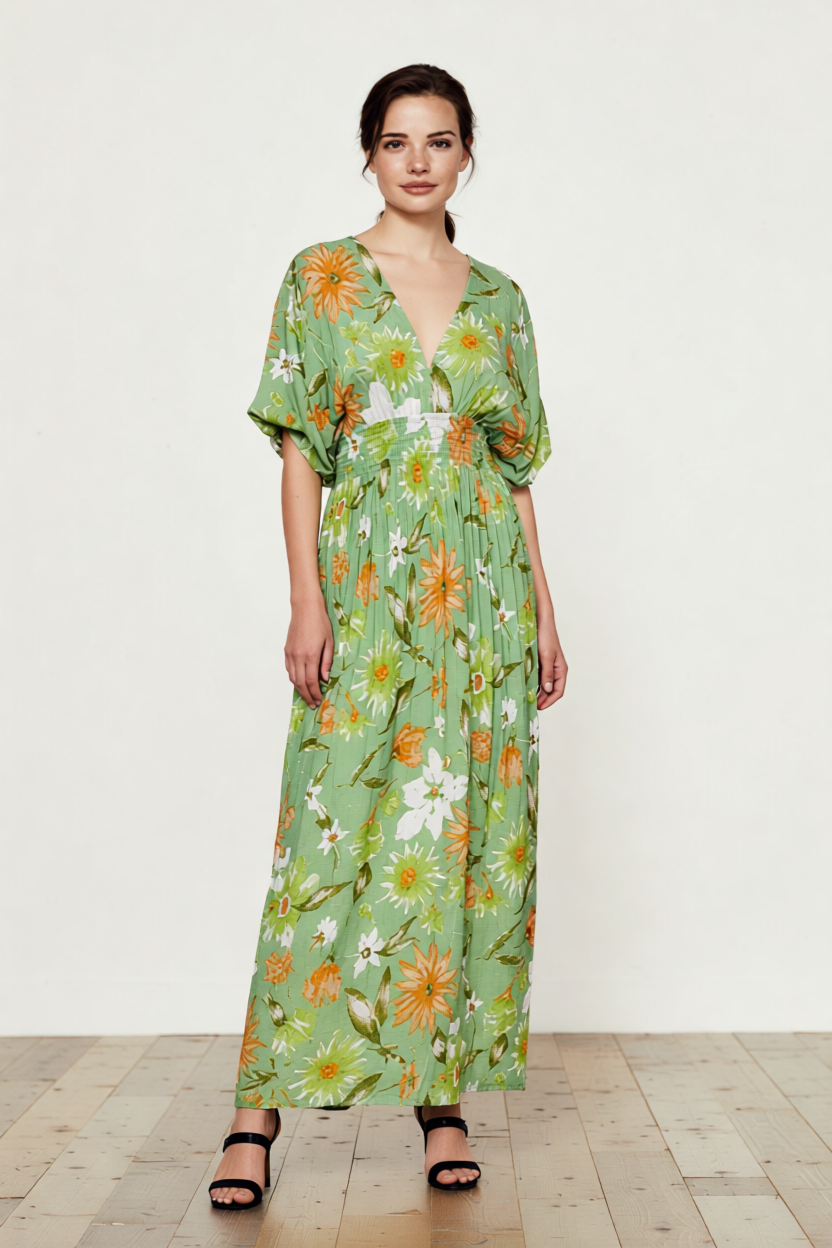 Woman wearing a green floral dress on a white background