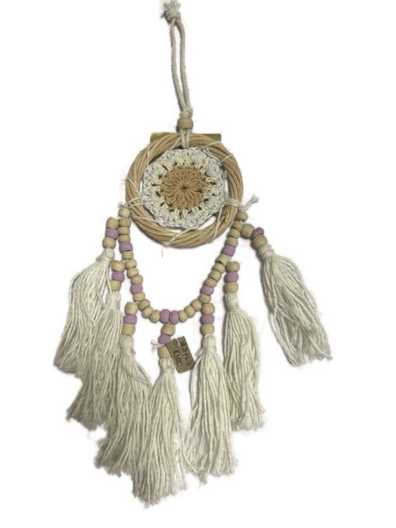 Decorative dreamcatcher with tassels and beads on a white background