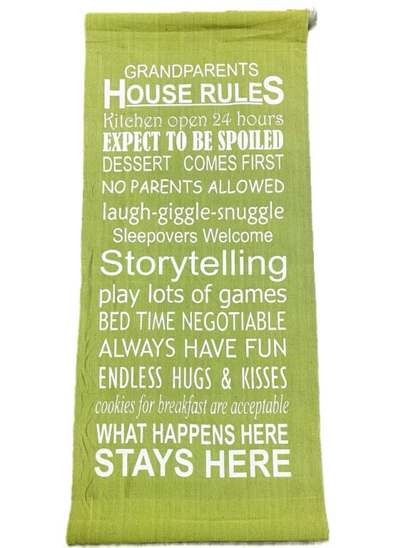 Green towel with white text displaying 'Grandparents House Rules' on a white background