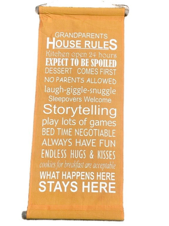 Orange towel with white text listing 'Grandparents House Rules' on a white background