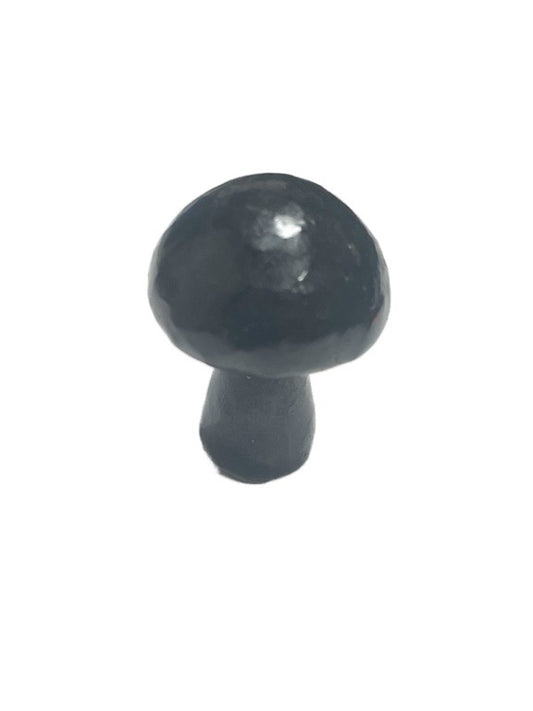 Black mushroom-shaped object on a white background