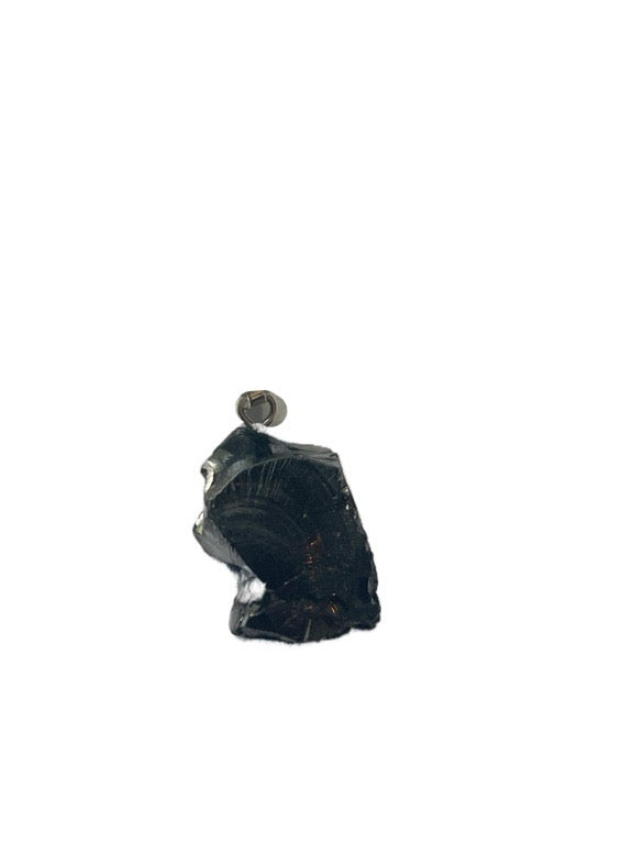 Black stone with a small metal object on a white background