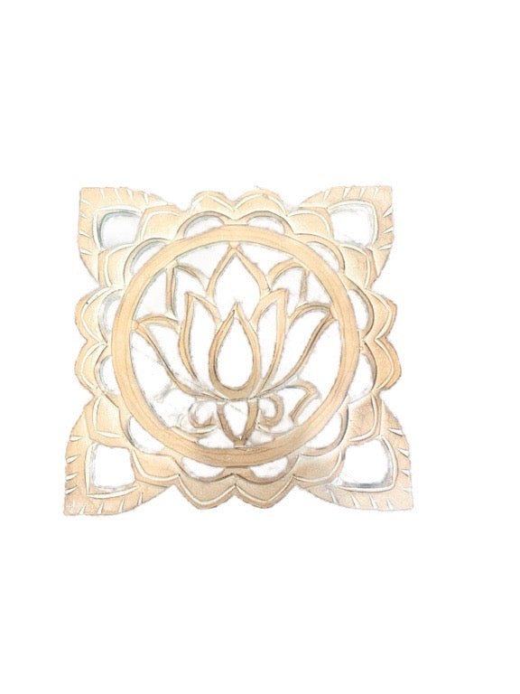 Decorative metal trivet with lotus design on a white background