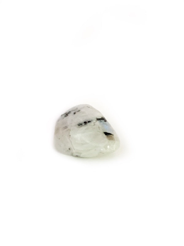 Clear gemstone with black inclusions on a white background