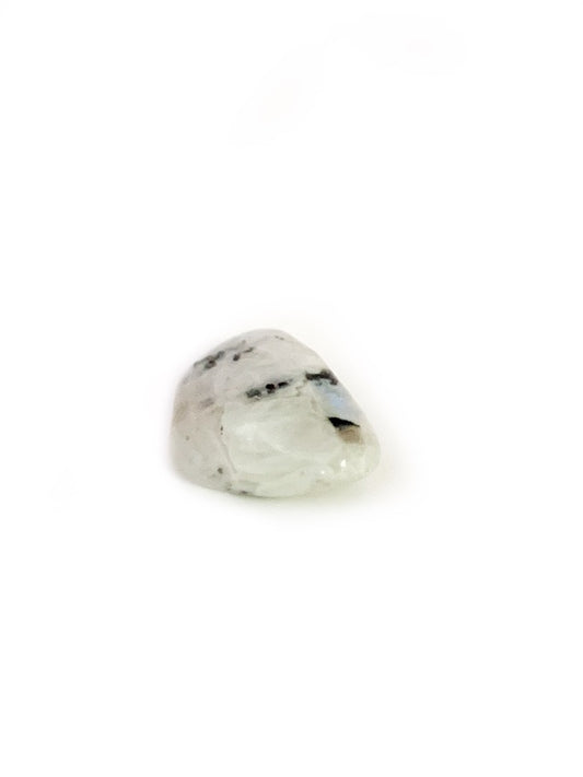 Clear gemstone with black inclusions on a white background