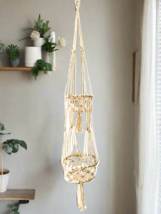 A bespoke handwoven macrame two-tier natural rope plant hanger, featuring two round wooden beaded baskets with sturdy hanging rope.